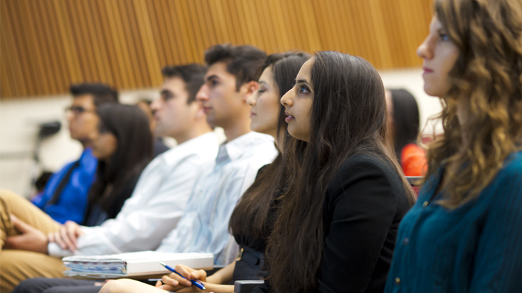 Students in class and listening to lecture